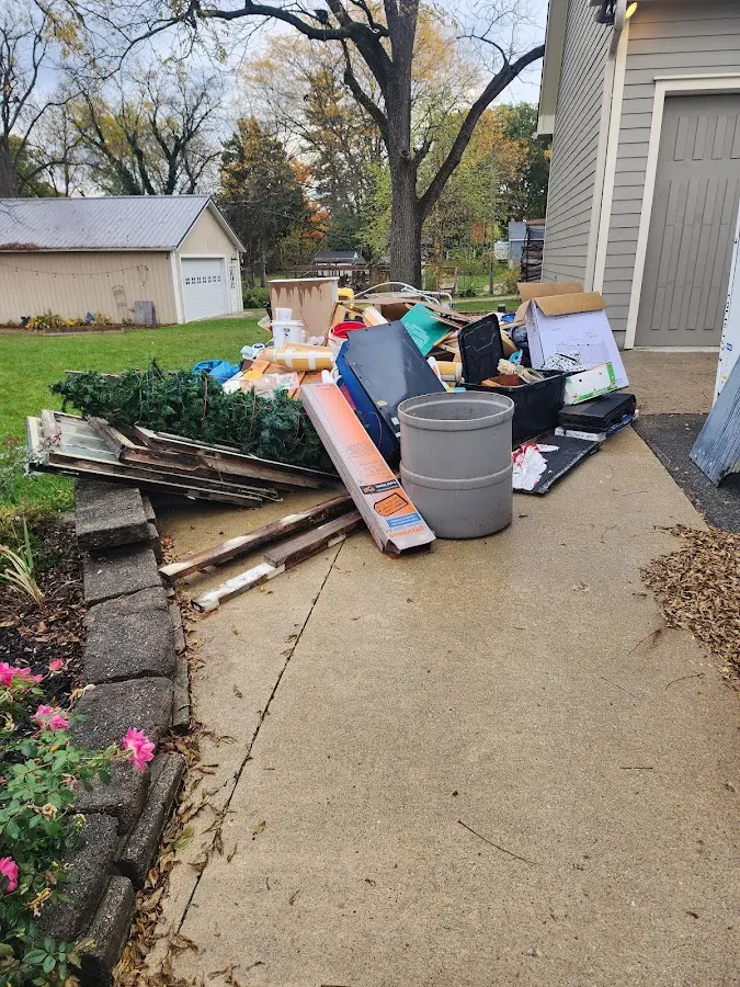Dumpster being loaded with debris for Estate Cleanout Dumpster Rental in Shiprock